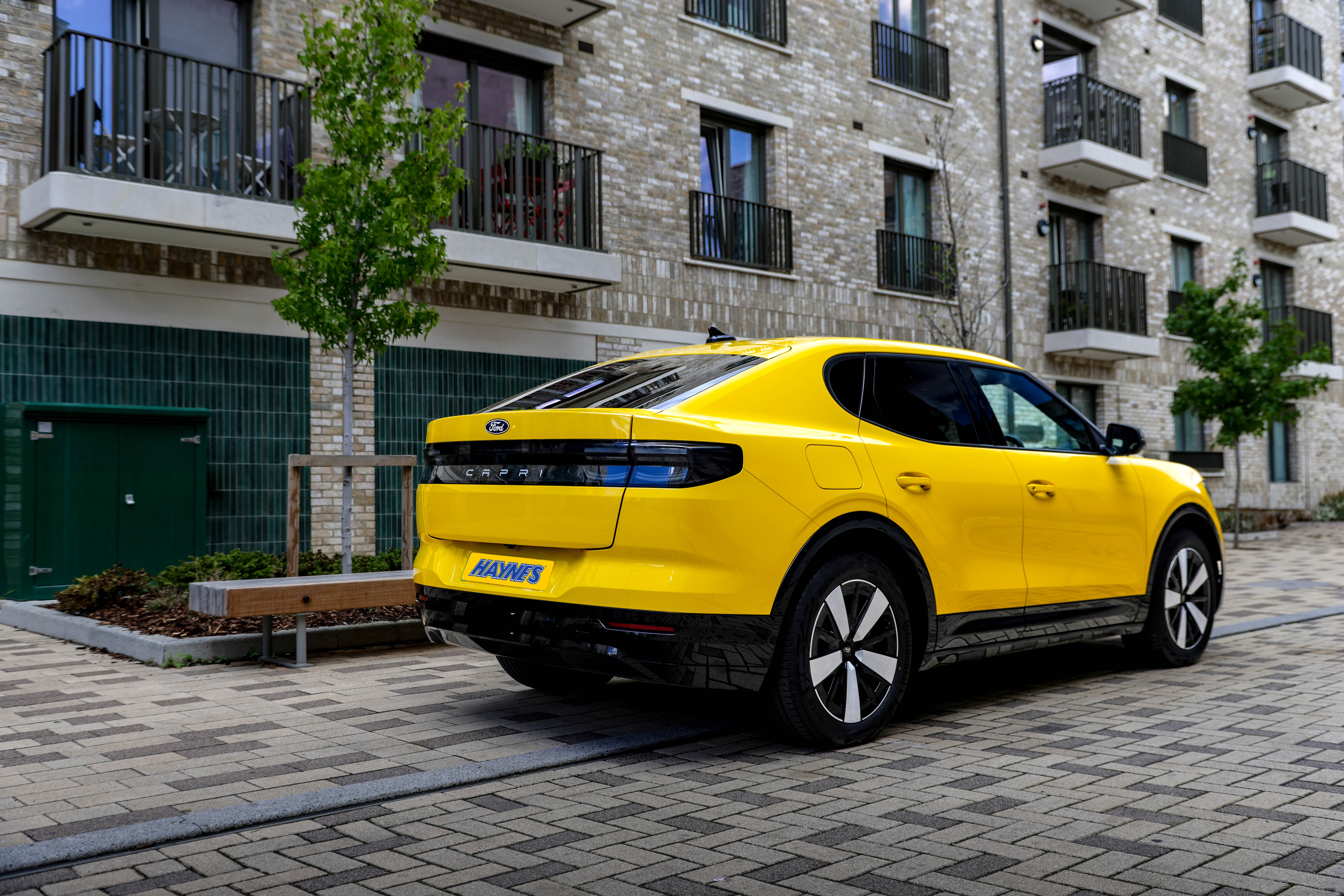 Yellow all-electric Ford Capri rear three quarter view
